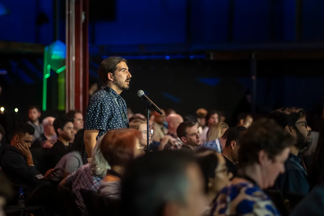 Attendee asking a question at the audience mic